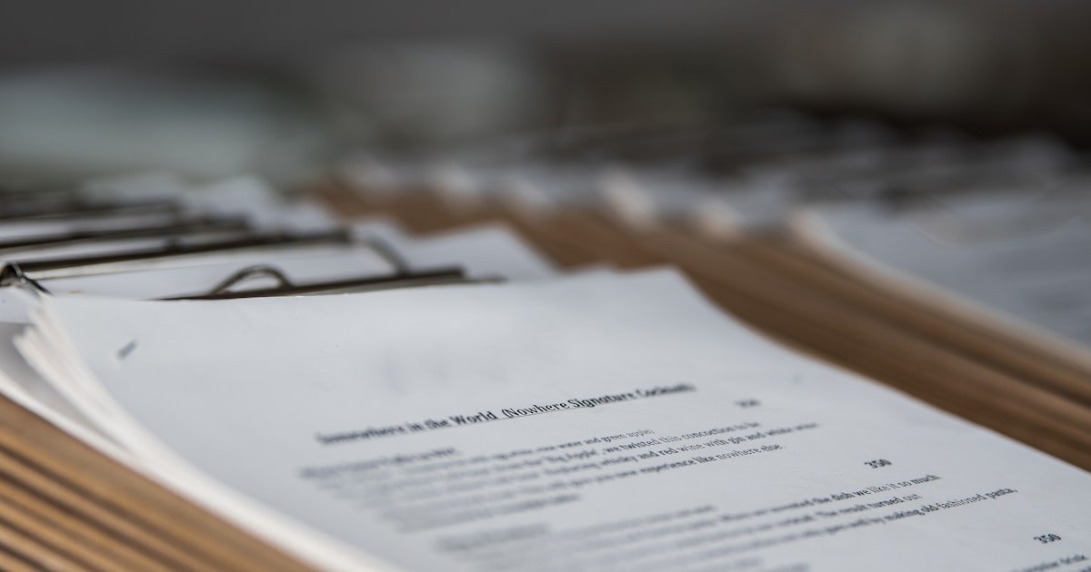 Documents and a pen on a desk, representing a credit report review