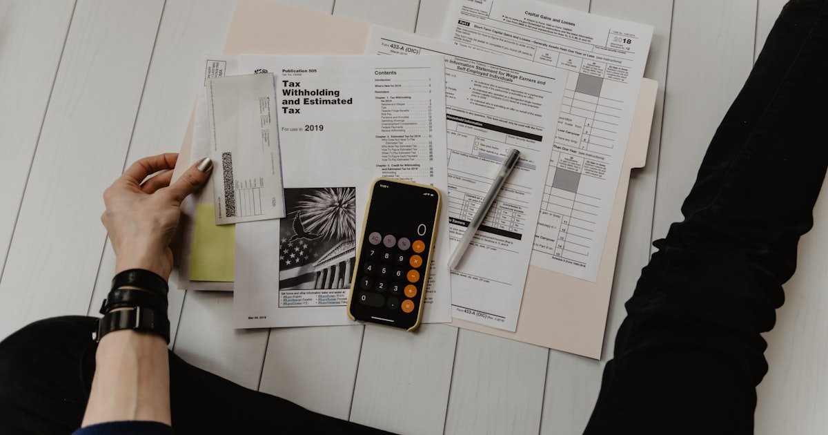 Person reviewing bills and calculating debt