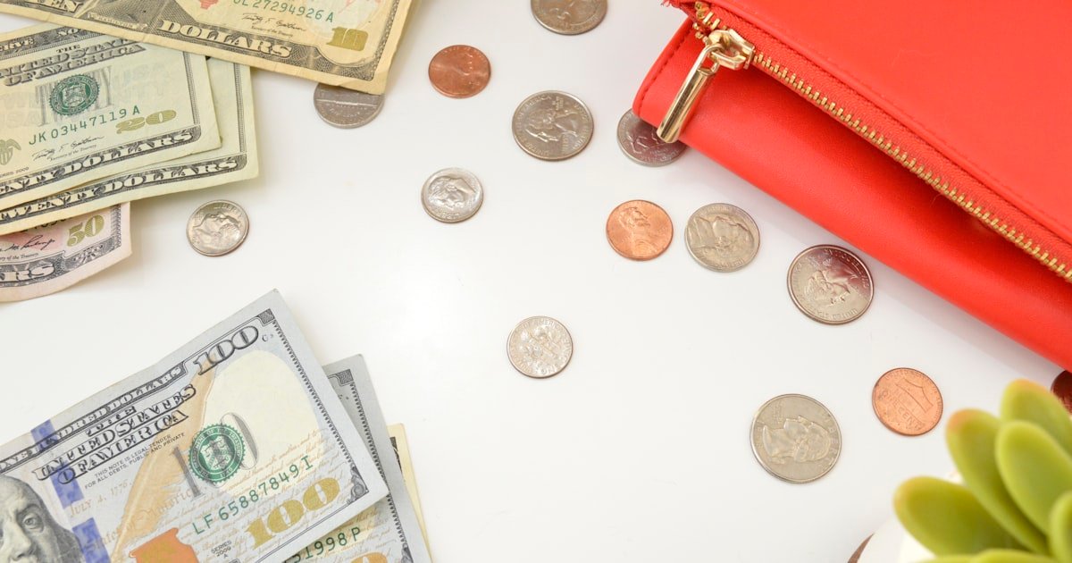 Person organizing cash into categories on a table
